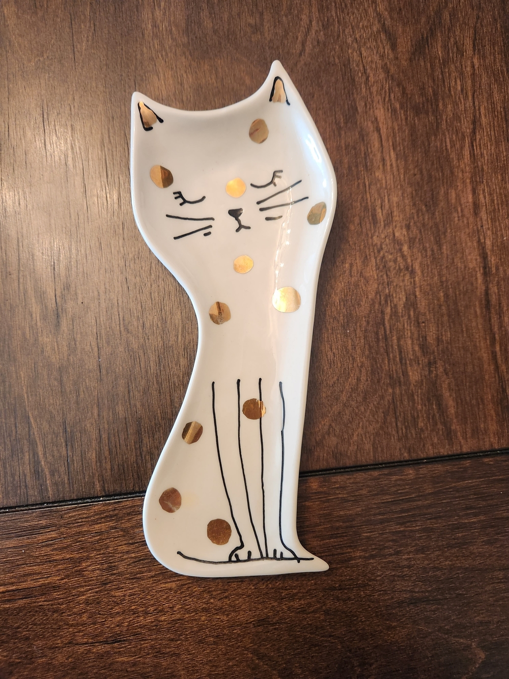 Anthropologie Gold Polka Dot Cat Spoon Rest made of white stoneware